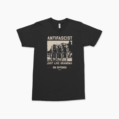 Black crewneck t-shirt with vintage-style graphic of armed women and text "ANTIFASCIST Just Like Grandma On Offense" in.