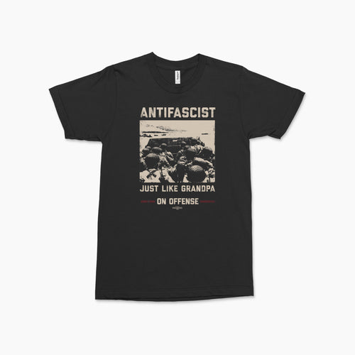 Black crew neck t-shirt with vintage-style beige print reading "ANTIFASCIST Just Like Grandpa On Offense" featuring a.